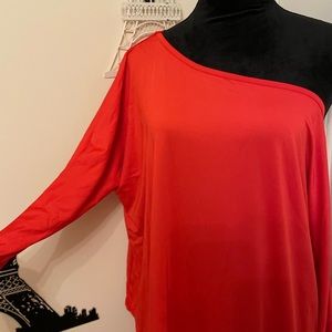 Red pant suit with hang off shoulder shirt.